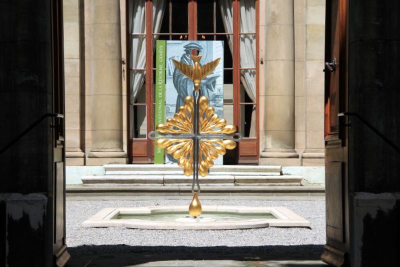 Golden peace dove in the courtyard of the Reformation Museum in Geneva