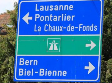 Road sign in Neuchatel pointing to Lausanne, Bern, Biel, Autoroute