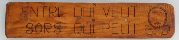 "Enter who wants to. Exit who can" — sign in at a wine cellar in Luins
