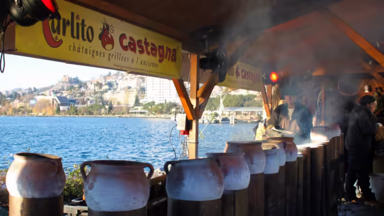 Hot chestnuts being grilled at the Marché de Noël à Montreux, the largest and best Christmas market to visit in the Lake Geneva region of Switzerland-